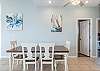 The open and spacious dining area features a table with plenty of seating to accommodate each member of your group.