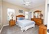 The front guest bedroom is located away from the others and is a perfect space for the early risers. Queen bedding is featured along with plenty of space for your personal belongings and also a private bathroom is included.