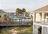 Sit on the porch and watch the swimmers enjoy a refreshing dip in the pool.