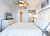The spacious primary bedroom features sumptuous king bedding, a private bathroom suite, and serene balcony access for your ultimate escape.