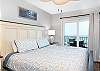 Gulf front primary bedroom features comfortable, king bedding and balcony access.