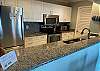 The spacious kitchen features granite countertops and stainless appliances