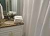 The guest bathroom offers a single vanity, with granite counter tops, and is fully stocked with linens for your stay.