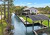 White Lane property is located in Gulf Shores on beautiful Plash Island, and features canal frontage, perfect for fishing and boating.