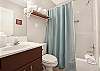 The guest bathroom features a tub/shower combo, single vanity, and is fully stocked with linens for your stay.