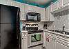 A refrigerator/freezer with ice maker is also offered in this fully stocked kitchen.