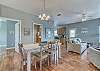 The open dining area offers a table with seating for 4 in chairs and also a bench that will hold at least 2