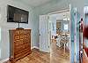 The bunk room offers a mounted television and also a chest of drawers