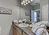 The private bathroom features a spacious vanity and allows all the room you need for dressing and styling for a night out on the town