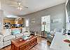 The living area offers a sleeper sofa, 2 easy chairs and a mounted television for enjoying in your down time.