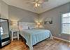 The primary bedroom offers king bedding, bedside tables with lamps and maintenance free flooring.