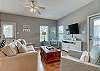 The spacious living area offers a sleeper sofa, 2 easy chairs, mounted television and is decorated with soothing, coastal colors 
