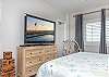 Unwind in bed after a long day on the beach and enjoy your favorite television show.
