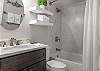 The guest bedroom features a single vanity, tub/shower combo, and is fully stocked with linens for your stay.