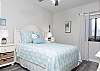 The guest bedroom features queen bedding and is decorated with a coastal vibe to welcome you for your beach stay.