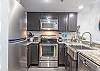 The spacious kitchen features both small and large appliances and is fully stocked with all items needed for preparing meals during your stay.