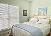 Bedroom 3 offers queen bedding, and beautiful coastal décor.