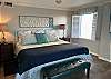 Beautiful king bedding is featured in the primary bedroom.