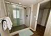 The primary bedroom features a luxurious en suite, private bathroom with tiled shower. A separate dressing area makes it convenient for couples to get ready for dinner or a night on the town.