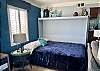 A cozy Murphy bed is featured in the living area to accommodate additional, overnight guests.
