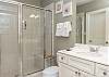 The guest bathroom features a spacious, standing shower, single vanity, and is fully stocked with linens for your stay.