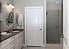 The private bathroom offers a separate water closet and a double vanity with plenty of space for all of your personal belongings.