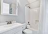 The guest bathroom features a tub/shower combo, single vanity, and is fully stocked with linens for your stay.
