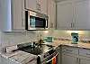 This beautiful kitchen offers custom cabinetry that is full of items needed for meal prepping during your stay.