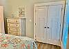 Guest bedroom 1 offers a large closet and chest of drawers for storing your personal belongings out of sight.