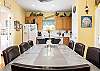 The open dining area features a table with seating for 8 with additional seating located at the adjacent bar. Imagine the game nights, conversations, and meals shared together in this cozy cottage. Memories in the making!
