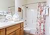 The guest bathroom can be accessed from the living area as well as Bedroom 2, and features a tub/shower combo, single vanity, and is fully stocked with linens for your stay.
