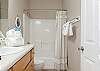 A private bathroom is featured with the primary bedroom which offers a tub/shower combo, single vanity, and is fully stocked with linens for your stay.
