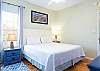The spacious primary bedroom features king bedding and is comfortably furnished for a great stay.