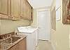 A large laundry area is offered which features a utility sink, and full size washer and dryer.