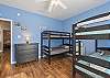 This guest bedroom features 2 sets of Twin bunk beds and is capable of sleeping 4.