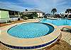 The main pool features a kiddie pool and small clubhouse with restrooms. Plenty of loungers and seating is also featured for enjoying some relaxing time in the sun.