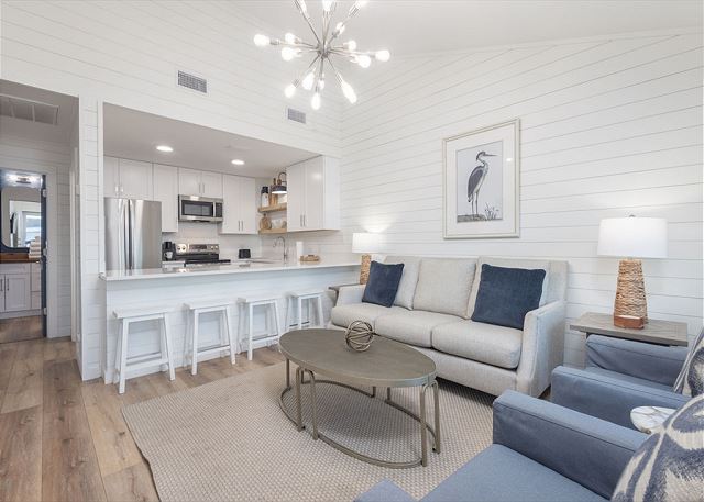 This cozy duplex unit is setup to utilize every square inch of space. The open living area flows seamlessly into the kitchen with dining in between  at the open bar. The large mounted television offers entertainment during your down time.