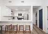 The spacious kitchen features an open bar with seating and is perfect for enjoying meals during your stay.