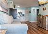 The spacious living area offers a comfortable sofa sleeper and a mounted television for enjoying in your down time.