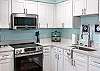 The fully stocked kitchen features new appliances and is ready for you to come prep your meals.