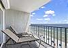 The spacious balcony offers loungers for enjoying a relaxing morning watching the waves crash on the shore.