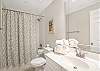 The private bathroom, located in Guest Bedroom 1, offers a tub/shower combo, single vanity, and is fully stocked with linens for your stay.