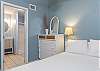 The loft features a full size bed, mirrored dresser, and private bathroom. Although it is an open loft, the space feels very private for guests.