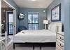The primary bedroom features Queen bedding and a television for enjoying in your down time.