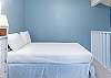 The open loft features a full size bed and a spacious, private bathroom.