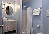 The loft bathroom features a standing shower, single vanity, and is fully stocked with linens for your stay.