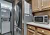 The kitchen boasts nice stainless appliances and for convenience, a stack washer/dryer is provided.
