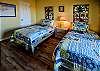 Bedroom 2 offers 2 twin beds and a flat screen television