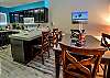 Dining table with seating for 4 with adjacent seating at the bar for 2