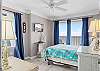 The Gulf Front Bedroom features queen bedding and balcony access. A television is also provided to help wind down at night after a long day on the beach.